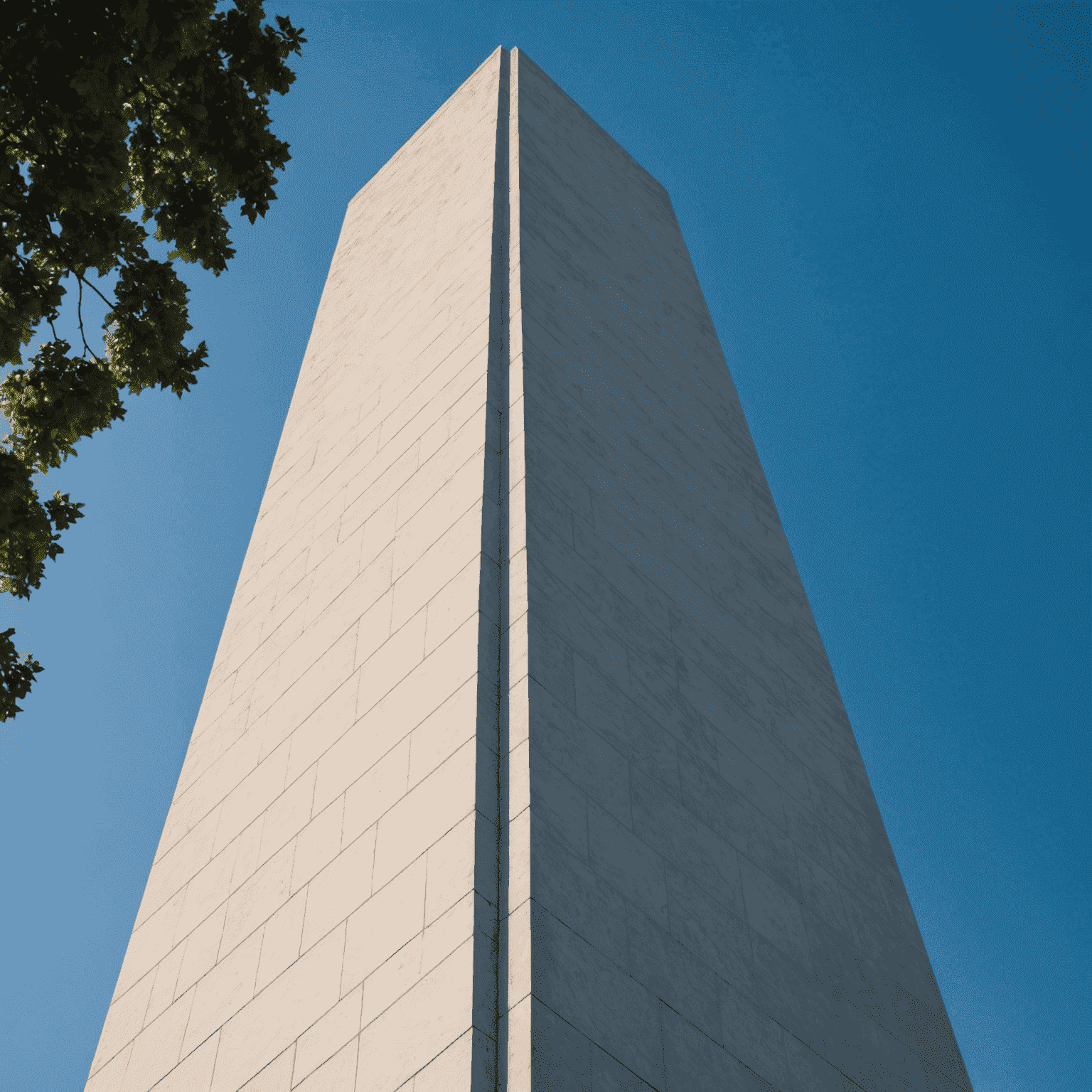 Close-up view of the Washington Monument against a clear blue sky